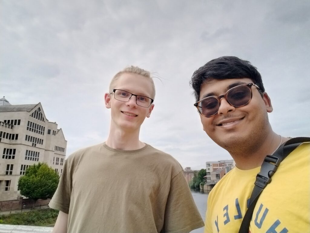 A photo of two students smiling at the camera.