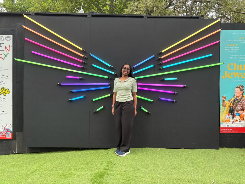 A student standing in front of colorful display.