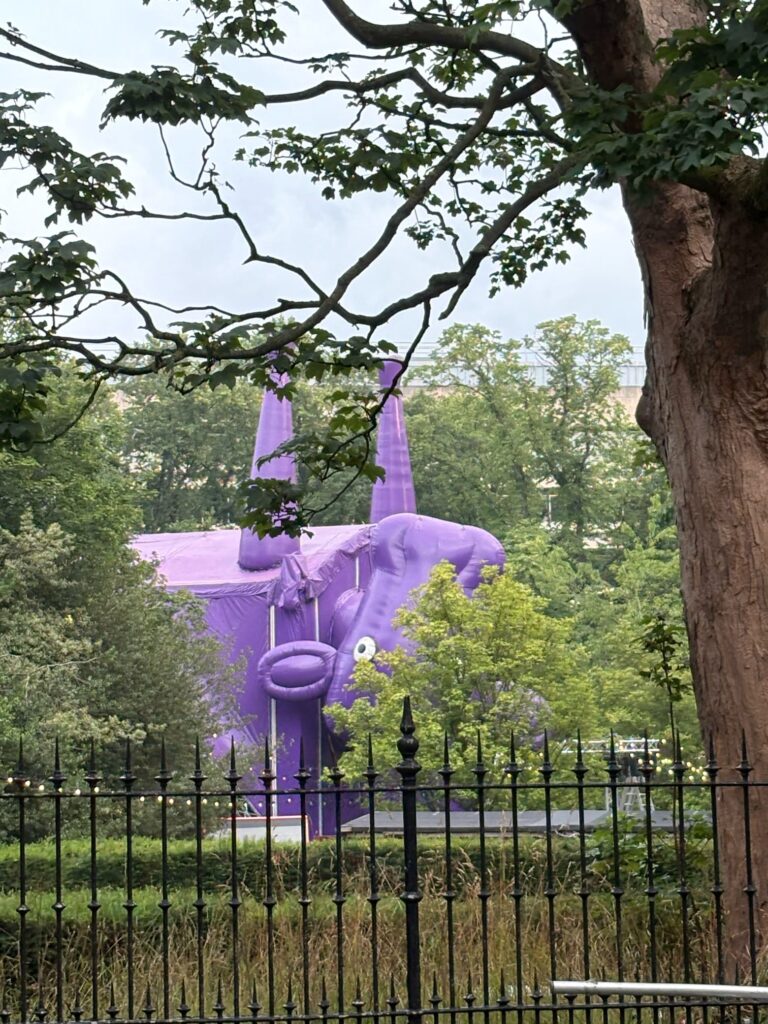 A photo of an inflatable purple hippo