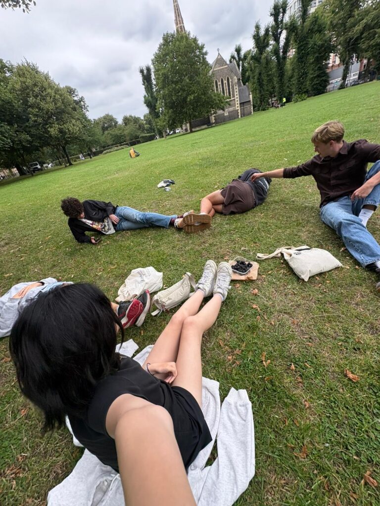 A photo of students sitting in the grass.