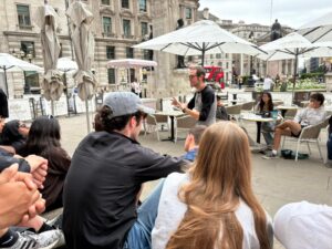 A photo of students listening to a tour guide.