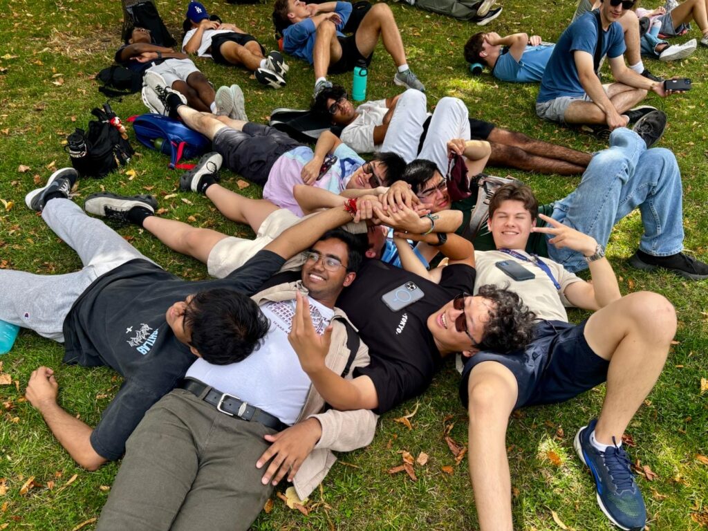 A group of students piled on top of each other.