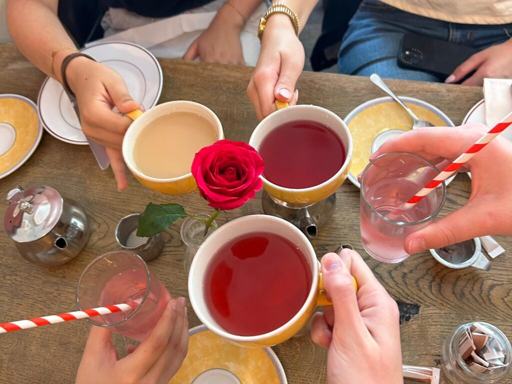 A group of students holding up their tea cups.